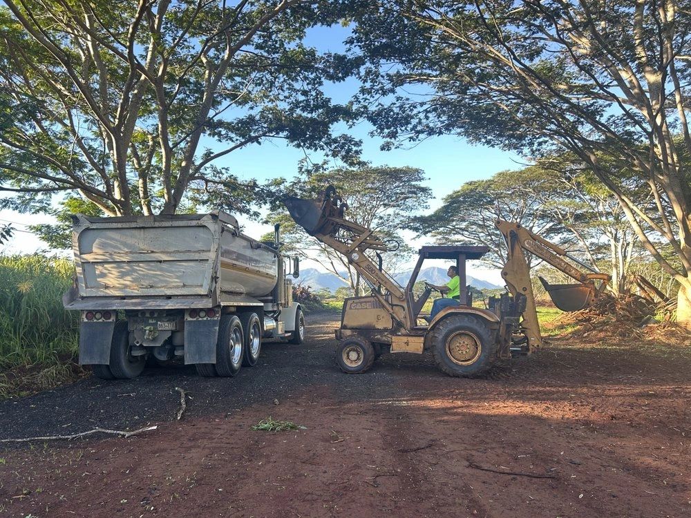 Loader placing soil into a BZ Services dump truck